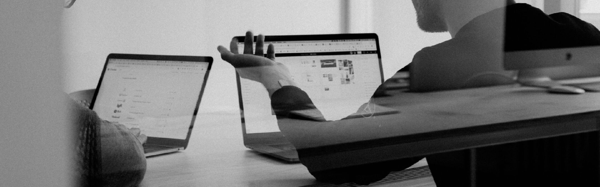 Two work mates reunited with their laptops and talking about work