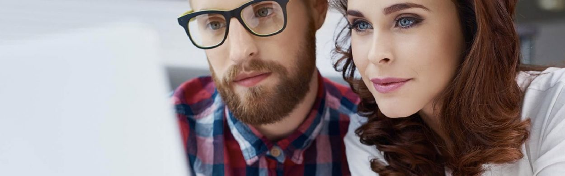 A woman and a men reading something from the pc.