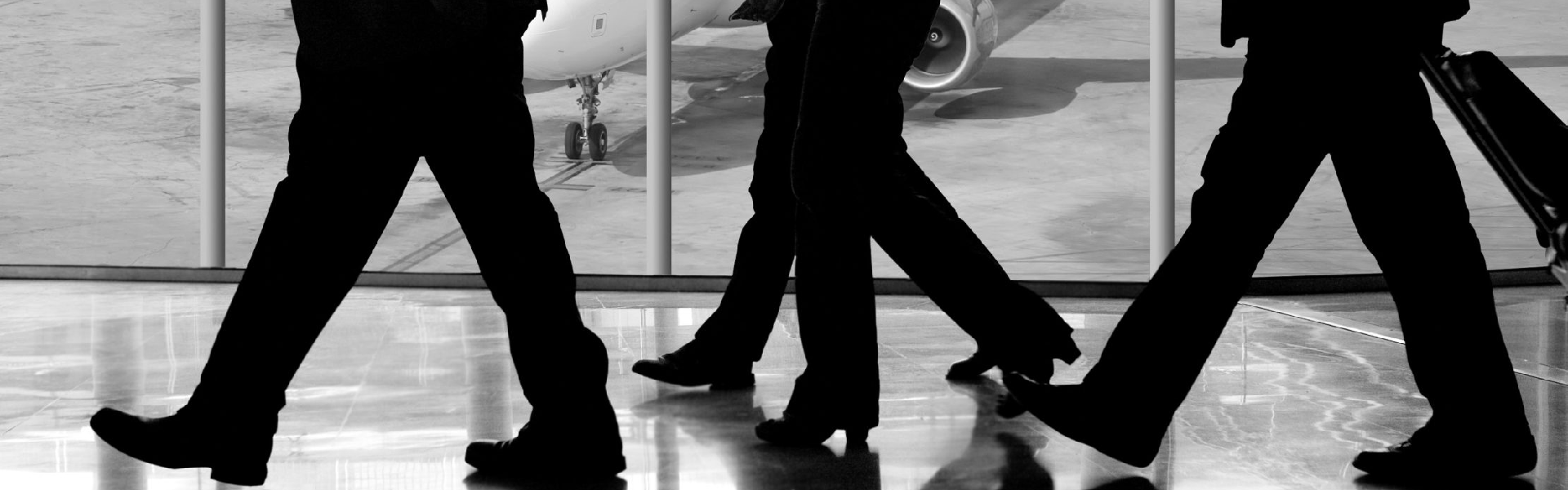 People walking in an airport. Black and white image